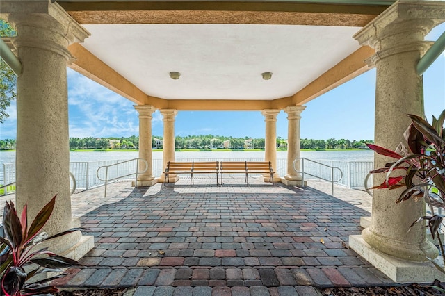 view of patio with a water view