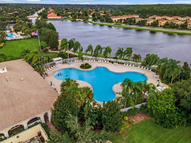 view of swimming pool featuring a water view and a patio