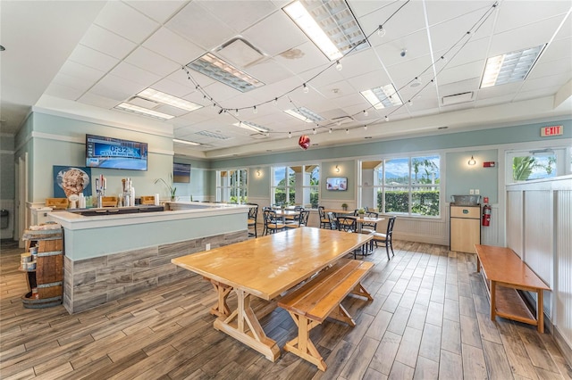 dining room featuring a drop ceiling and wood-type flooring