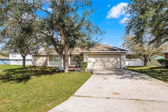 ranch-style home featuring a garage and a front lawn