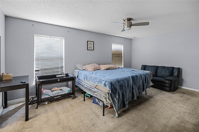 carpeted bedroom with a textured ceiling and ceiling fan