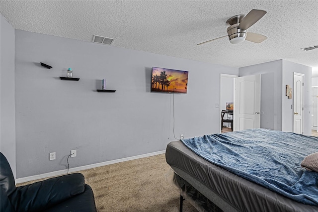 bedroom featuring ceiling fan, carpet flooring, and a textured ceiling