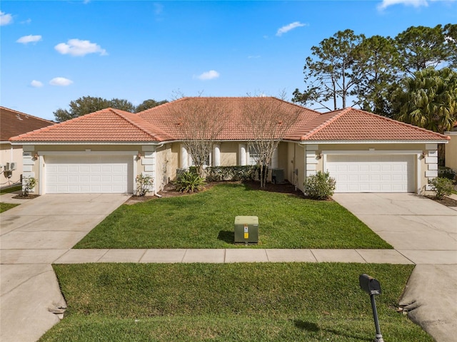 mediterranean / spanish-style home with a garage, central AC, and a front lawn