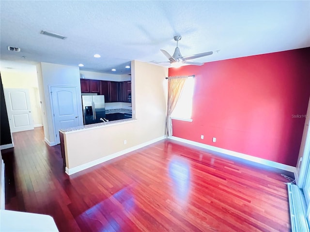 living room featuring ceiling fan, dark hardwood / wood-style flooring, and a baseboard radiator