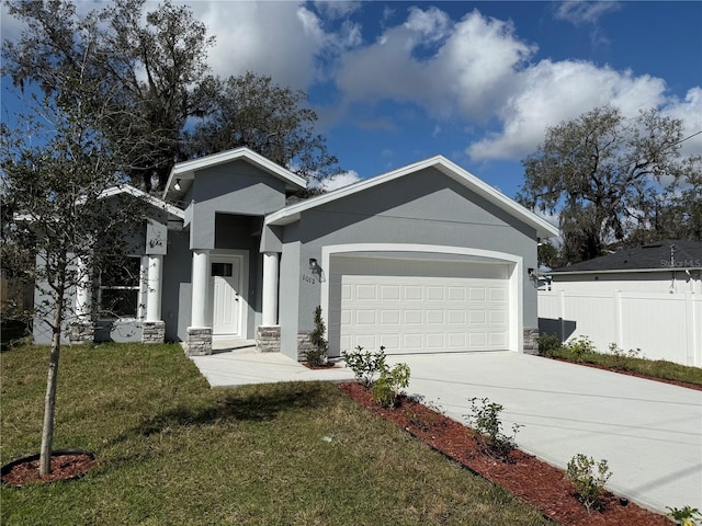 view of front of property with a garage and a front lawn