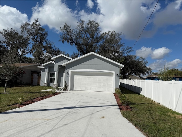 view of front of house with a garage and a front lawn