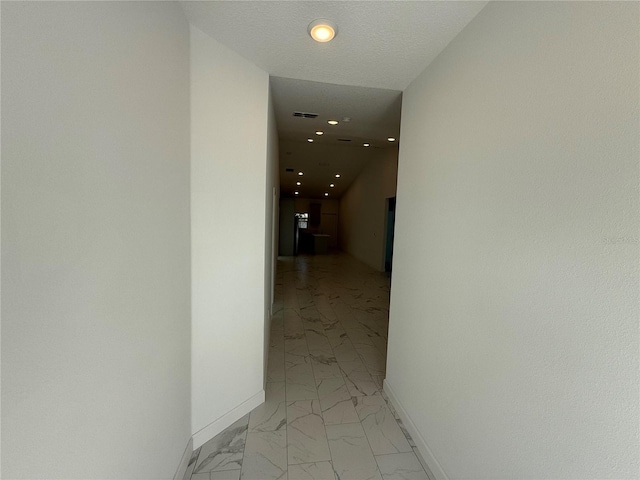 hallway featuring a textured ceiling