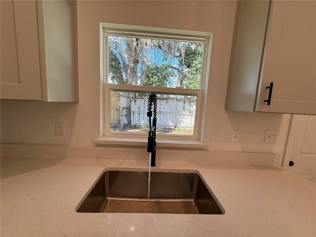 interior details with light stone counters and sink