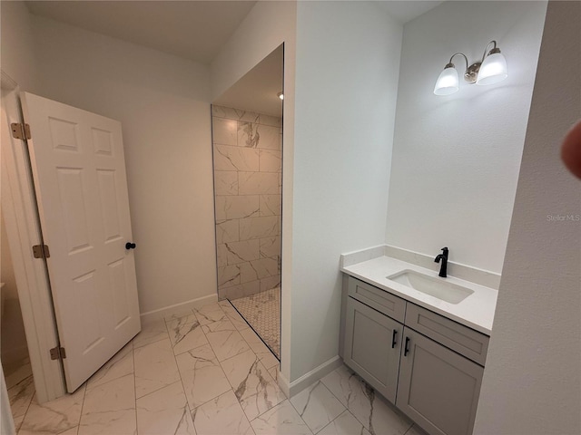 bathroom with vanity and tiled shower