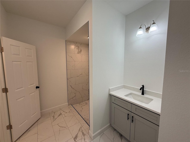 bathroom with vanity and tiled shower