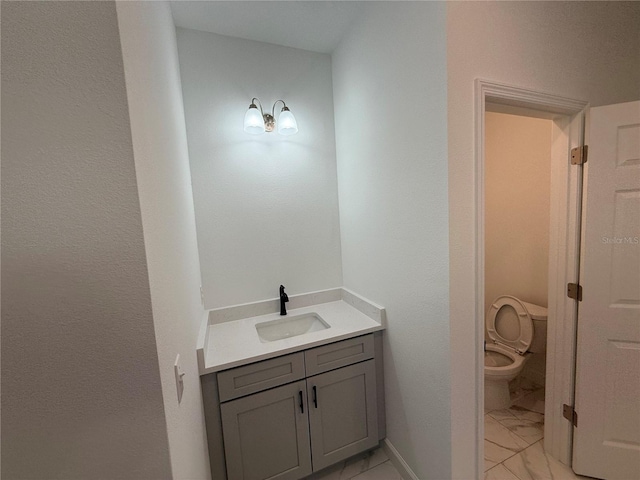 bathroom featuring vanity and toilet