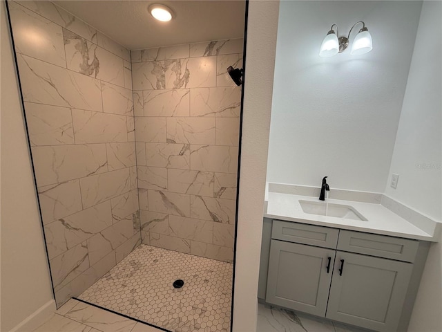 bathroom with vanity and tiled shower