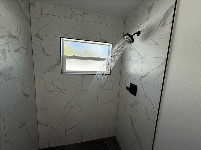 bathroom with a tile shower