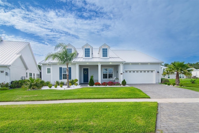 view of front of house featuring a garage and a front lawn