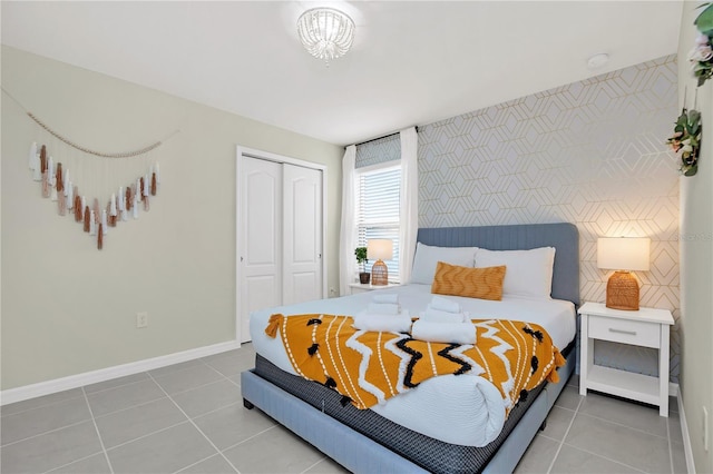 bedroom featuring light tile patterned floors and a closet