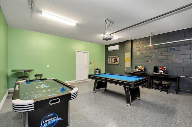 game room featuring a wall mounted AC, a textured ceiling, and pool table