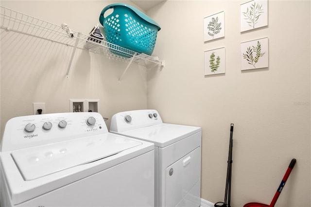 clothes washing area with washing machine and clothes dryer