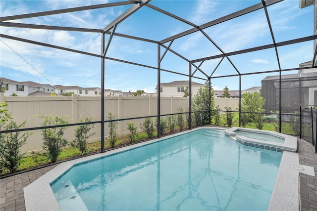 view of swimming pool featuring an in ground hot tub, a lanai, and a patio area