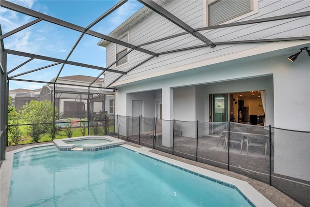 view of pool featuring an in ground hot tub, a lanai, and a patio