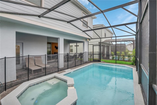 view of swimming pool featuring a lanai and an in ground hot tub