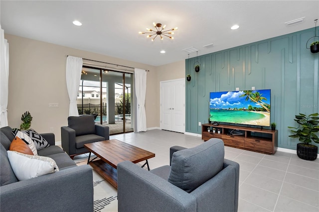 living room featuring light tile patterned flooring and an inviting chandelier