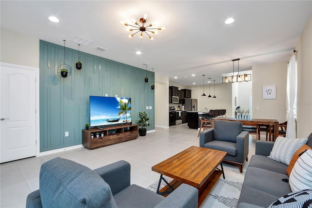 living room featuring light tile patterned flooring and a chandelier