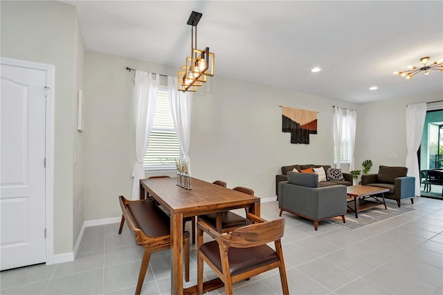 tiled dining room with a notable chandelier