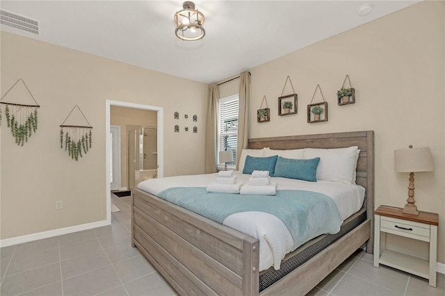 tiled bedroom featuring ensuite bathroom