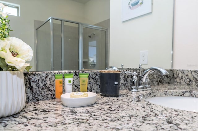 bathroom featuring vanity and an enclosed shower