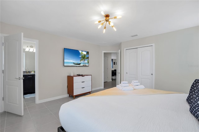 tiled bedroom with a closet and a notable chandelier