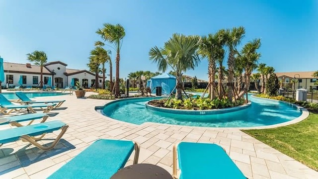 view of swimming pool with a patio area