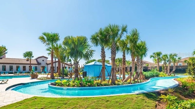 view of pool with a yard