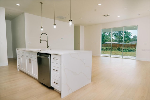 kitchen featuring pendant lighting, sink, an island with sink, white cabinets, and stainless steel dishwasher