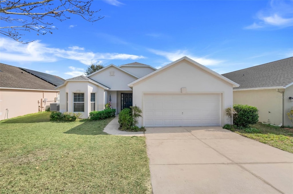 ranch-style house with cooling unit, a garage, and a front lawn