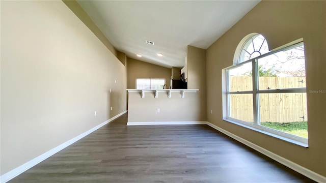 unfurnished room with visible vents, baseboards, dark wood-style flooring, vaulted ceiling, and recessed lighting