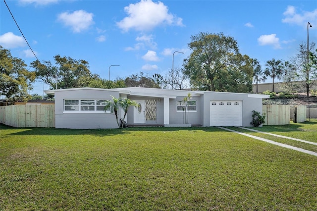 ranch-style house featuring a garage and a front yard