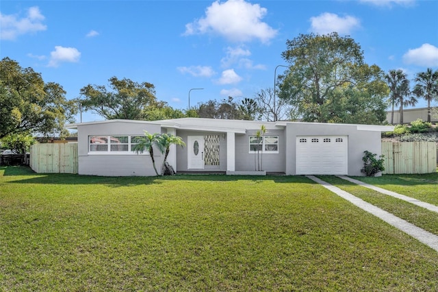 ranch-style home featuring a garage and a front lawn