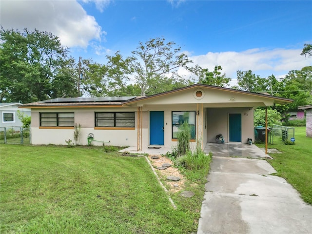 single story home with a front yard and a carport