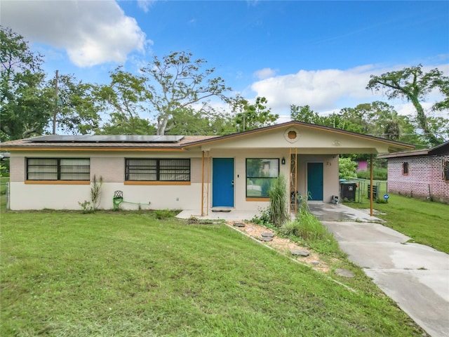 ranch-style home with a carport and a front yard