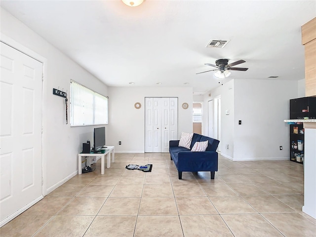 living room featuring ceiling fan and light tile patterned floors