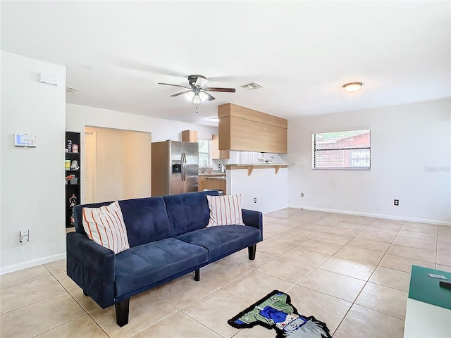 tiled living room with ceiling fan