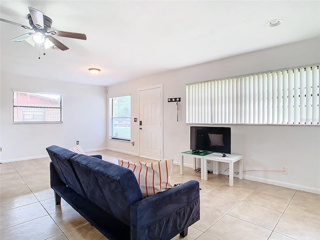 living room featuring light tile patterned floors and ceiling fan