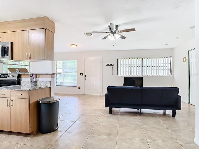 living room featuring ceiling fan and light tile patterned floors