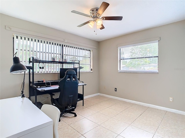 tiled home office featuring ceiling fan