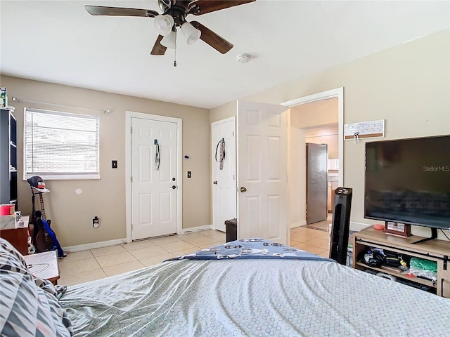 tiled bedroom featuring ceiling fan and stainless steel fridge