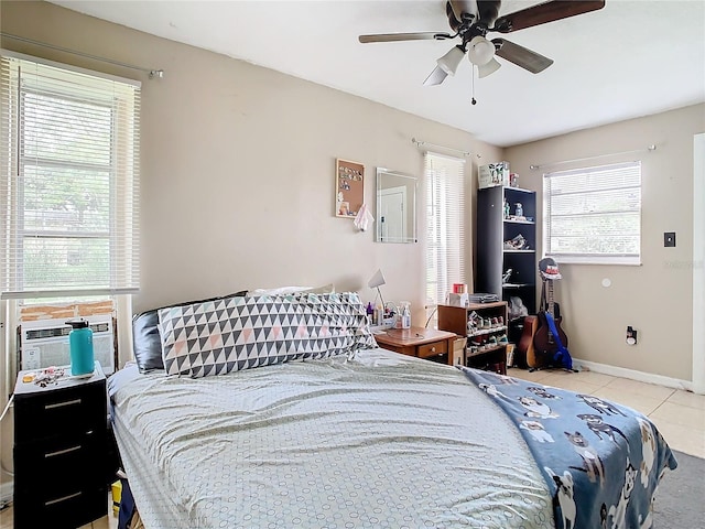 tiled bedroom featuring ceiling fan