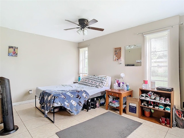 tiled bedroom featuring ceiling fan