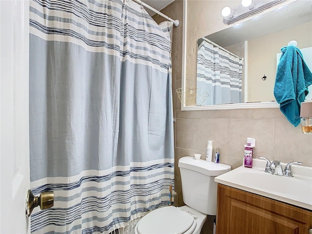 bathroom with vanity, tile walls, toilet, and a shower with shower curtain