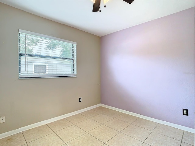 tiled empty room with ceiling fan