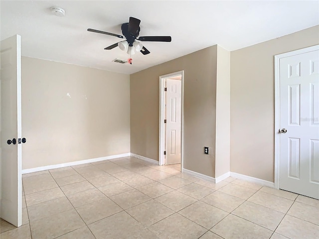 spare room with light tile patterned flooring and ceiling fan